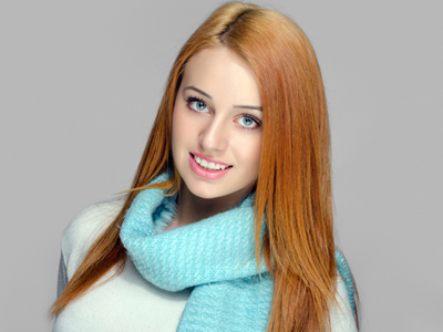 Portrait of a beautiful red hair woman wearing a blue scarf